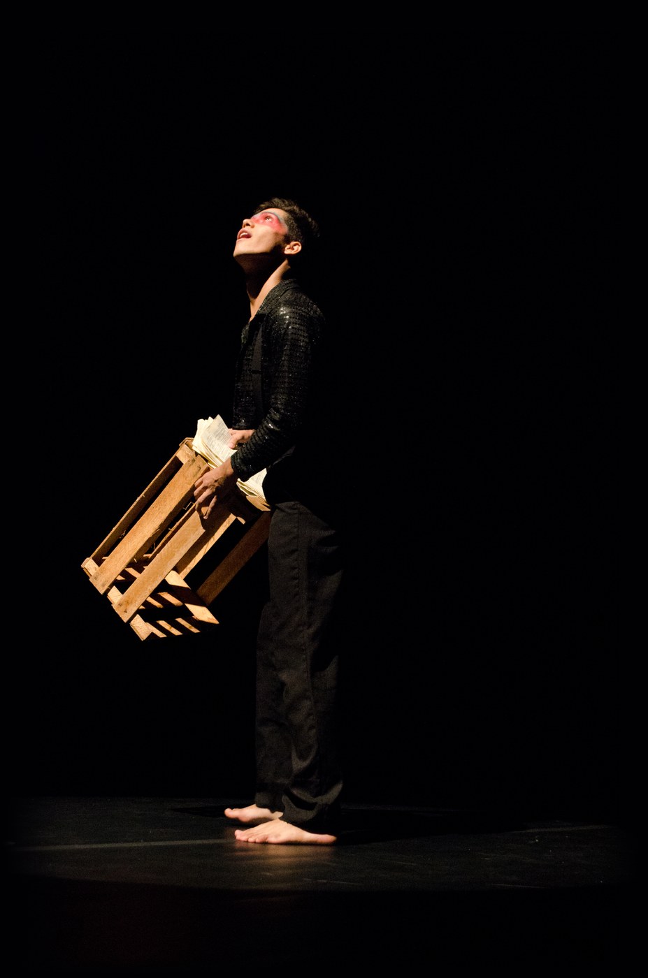 Bruno DiSanto on stage as The Dreamer in Liberty, looking up into the light