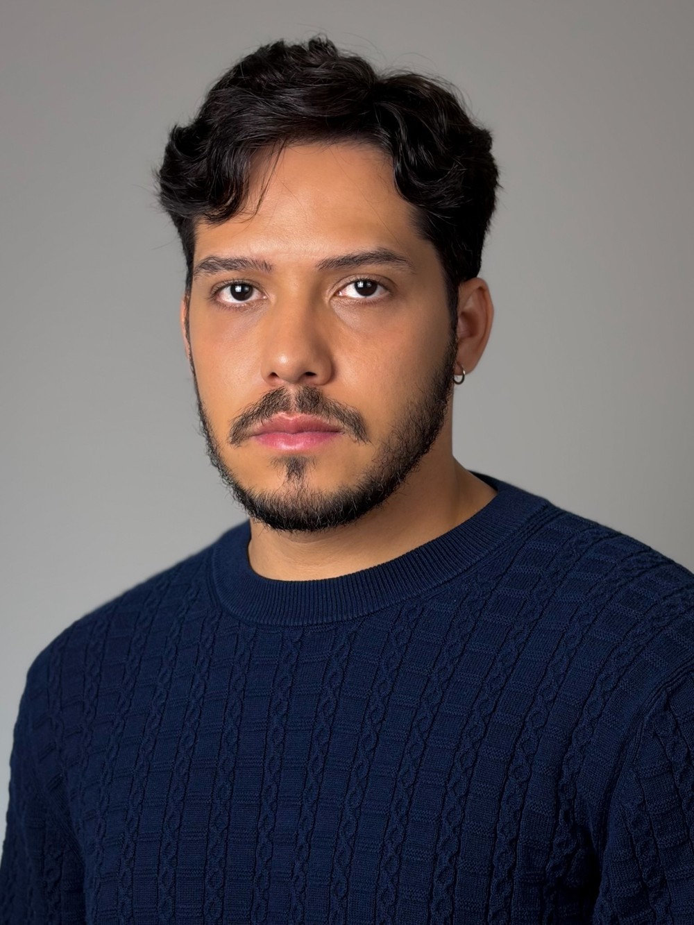 Bruno DiSanto, headshot in a navy sweater
