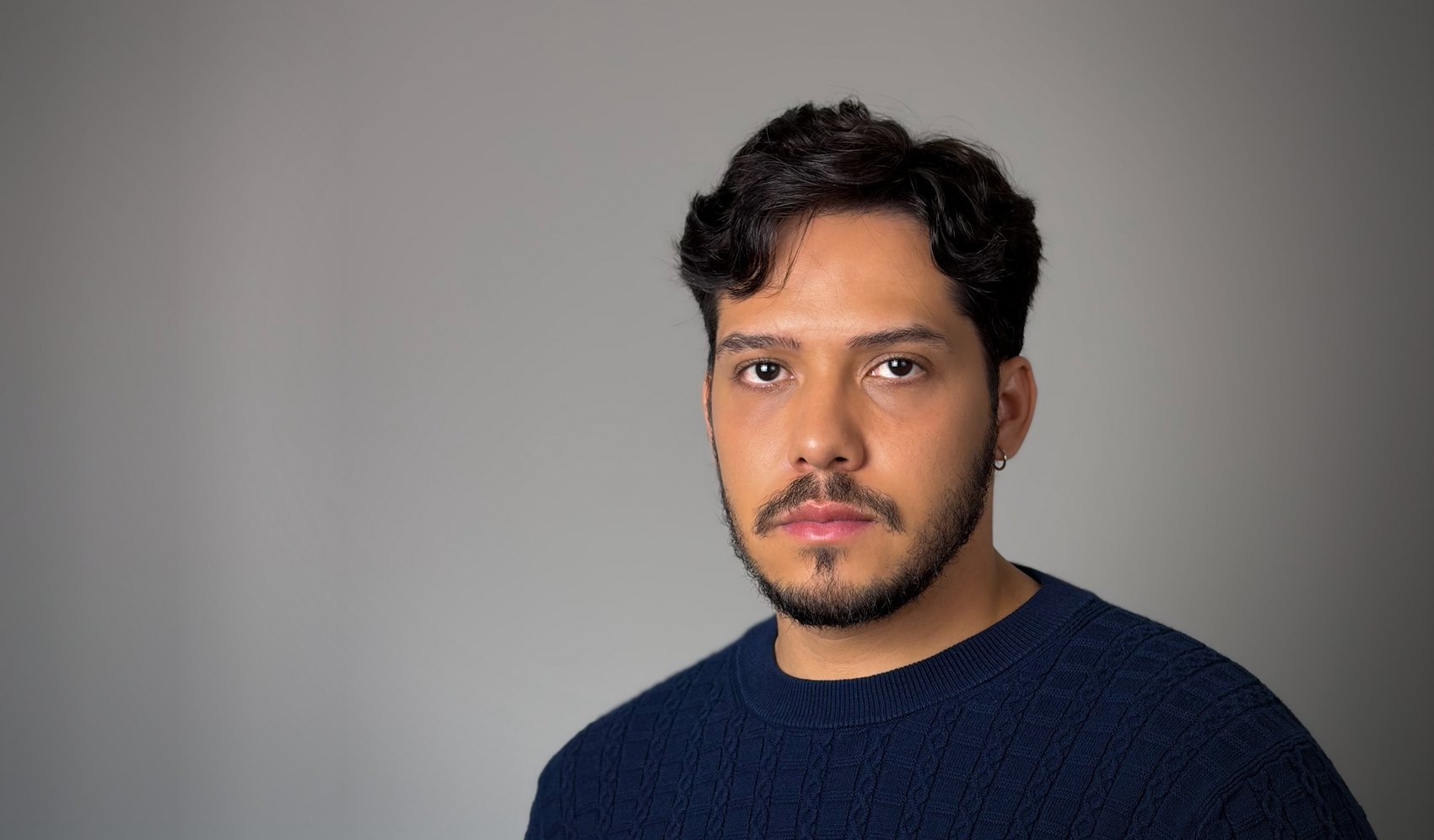 Bruno DiSanto, studio portrait in a navy sweater