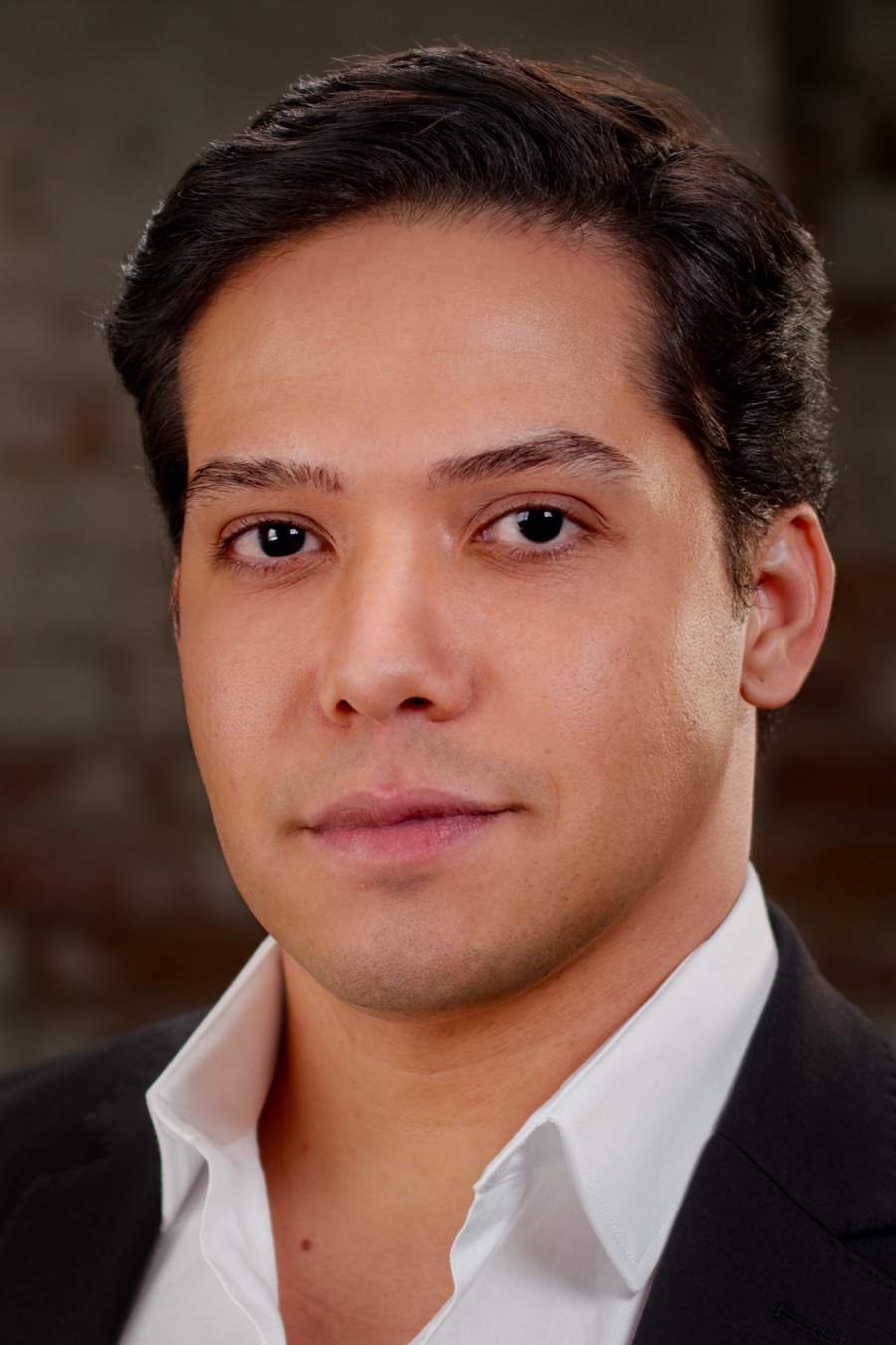 Bruno DiSanto, headshot in a white shirt and dark blazer